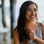 smiling woman in gray tank top