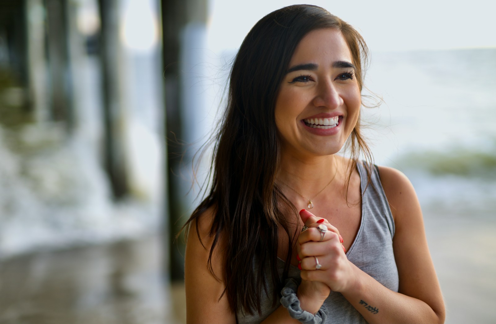 smiling woman in gray tank top